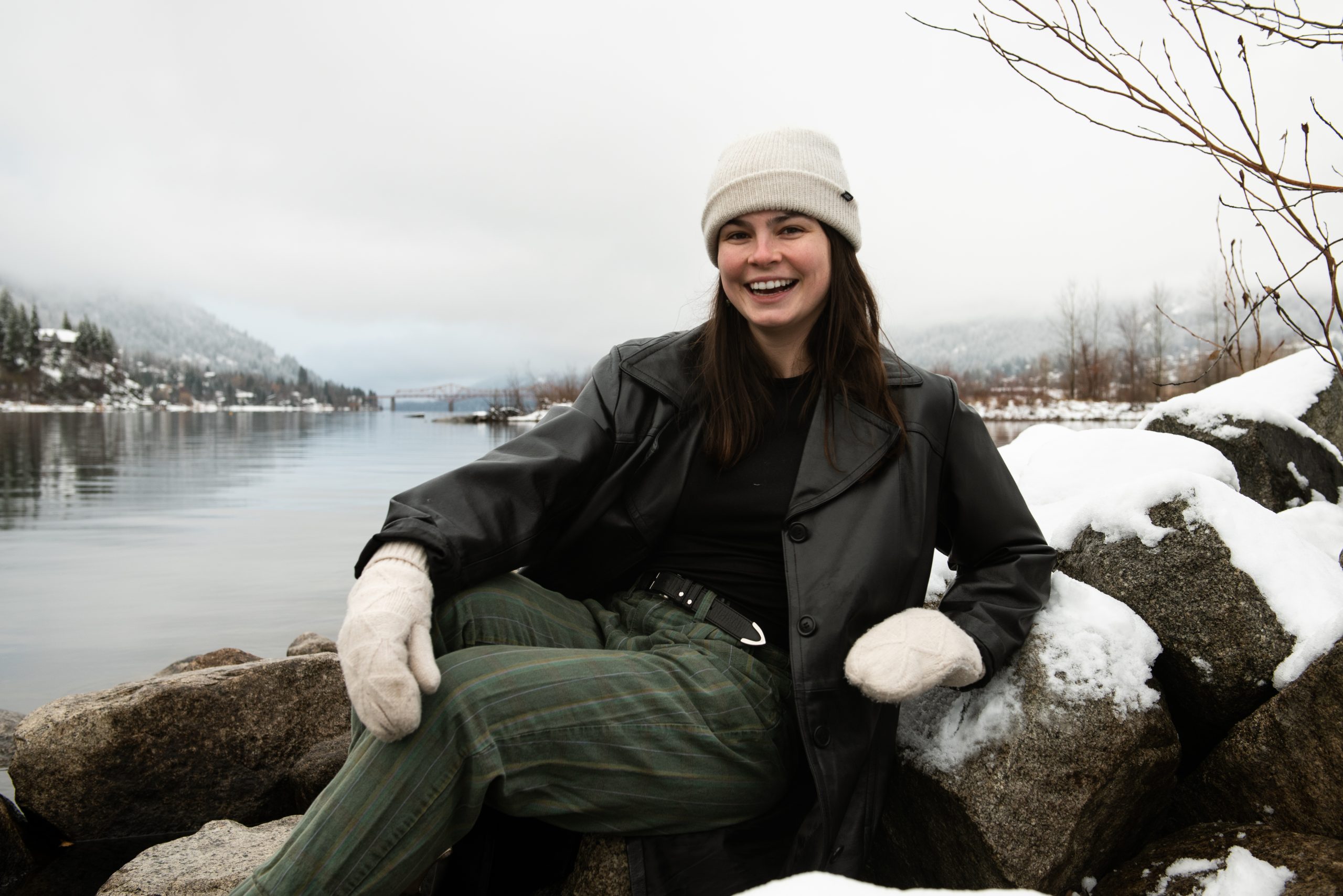 Quinn Bucciol sitting in front of Kootenay Lake